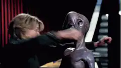 Ellen Ripley hugs the alien