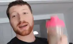 Man shaking protein shaker