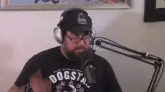 man in dogstar shirt talking into microphone