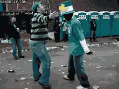 Two men dancing in St. Patrick's Day outfits