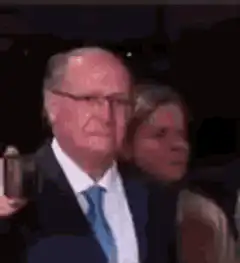 Man in suit smiles at camera