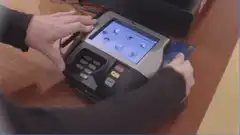 person swiping credit card on payment terminal