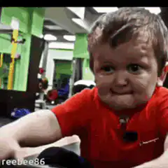 Toddler struggling to lift barbell