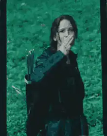 Katniss Everdeen salutes with three fingers