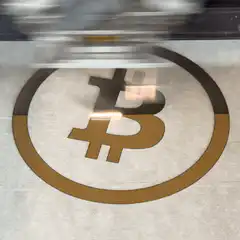 Bitcoin logo on floor with moving reflection