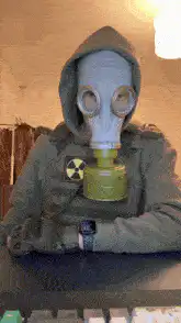 Person in gas mask shows radiation card