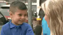 Cute boy shyly covers his face during interview