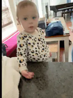 Toddler in leopard print staring blankly