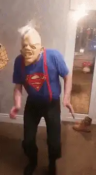 Elderly man in Superman shirt dancing