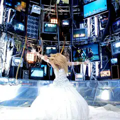 blonde woman in white dress dancing in front of tvs