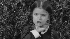 Wednesday Addams finger wag