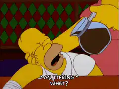 Marge pours coffee into sleeping Homer's mouth