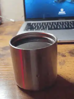 metal cup with red light reflection