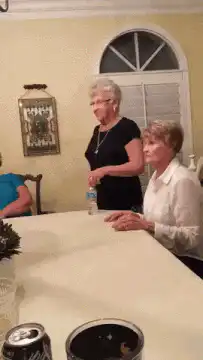 Two women dancing at a table