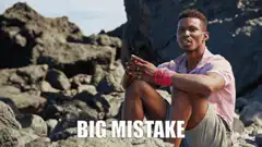 Man sitting on rocks looking regretful