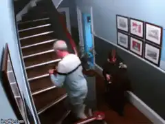 Man falls down stairs while woman paints
