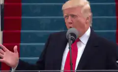 Donald Trump speaking at a podium