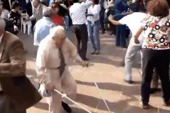 Elderly man dancing with cane