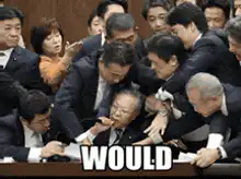 Japanese politician being held down at desk