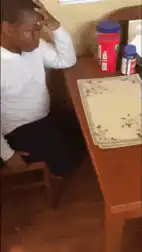 Man slaps table in frustration