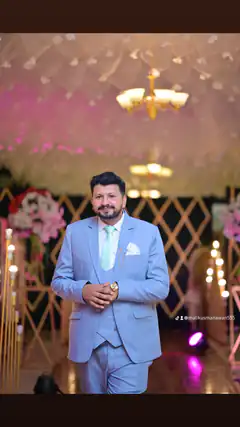 Man in light blue suit at wedding