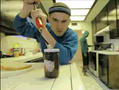 Man uses screwdriver to open jar