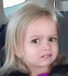Blonde girl side-eyeing in car seat