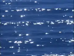 sunlight sparkling on blue water