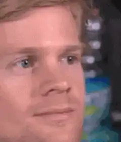 Man blinking and smiling