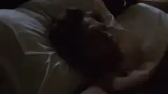 woman smiling at man in bed