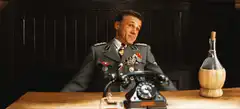 Hans Landa shrugs at desk