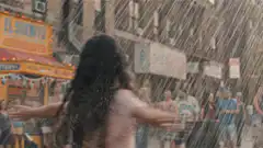 Girl dancing in the rain on a city street
