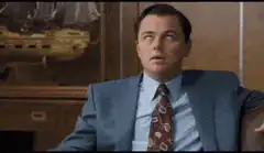 Leonardo DiCaprio coughing in a suit
