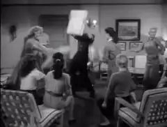 Man stands on table with arms outstretched