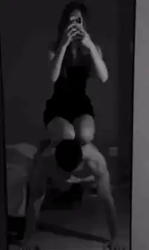 woman sitting on man doing pushups