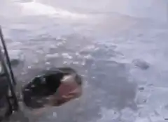 Man climbs out of ice hole with hockey stick