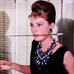 Audrey Hepburn smoking a long cigarette holder