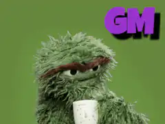 Oscar the Grouch drinking coffee with GM text