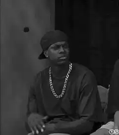 man in chain nodding and looking around