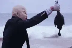 Baby holding a dead bird screaming