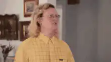 Man in yellow shirt talking