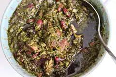 bowl of green stew with beans and meat