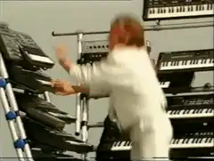 Rick Astley playing keyboards