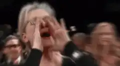 Meryl Streep yelling with hands cupped