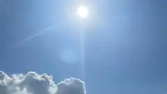 bright sun in blue sky with clouds