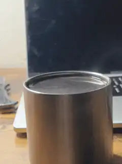 Steam rising from a metal cup