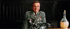 Hans Landa laughing at his desk