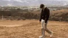 Man walking slowly with head down