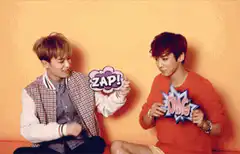 Two men holding comic book signs