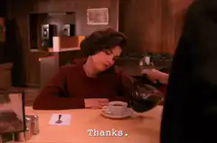Woman drinking coffee in diner